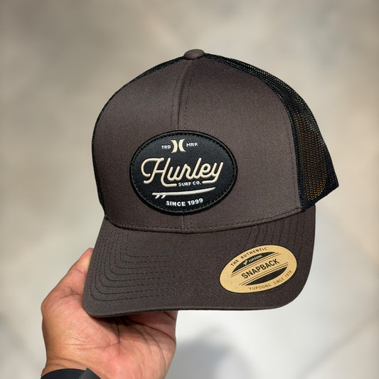 Hurley trucker dark brown cursive font