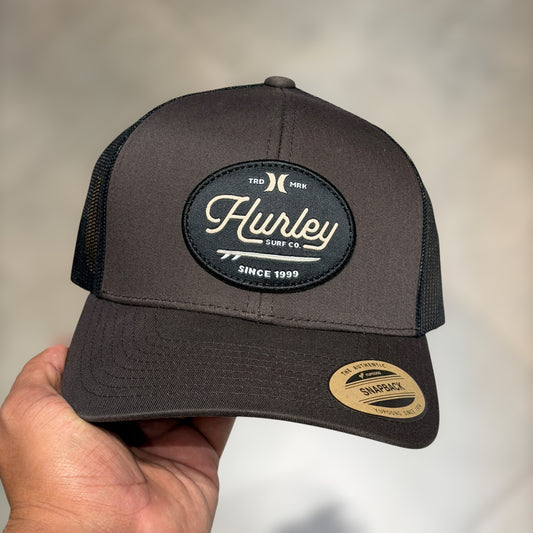 Hurley trucker dark brown cursive font